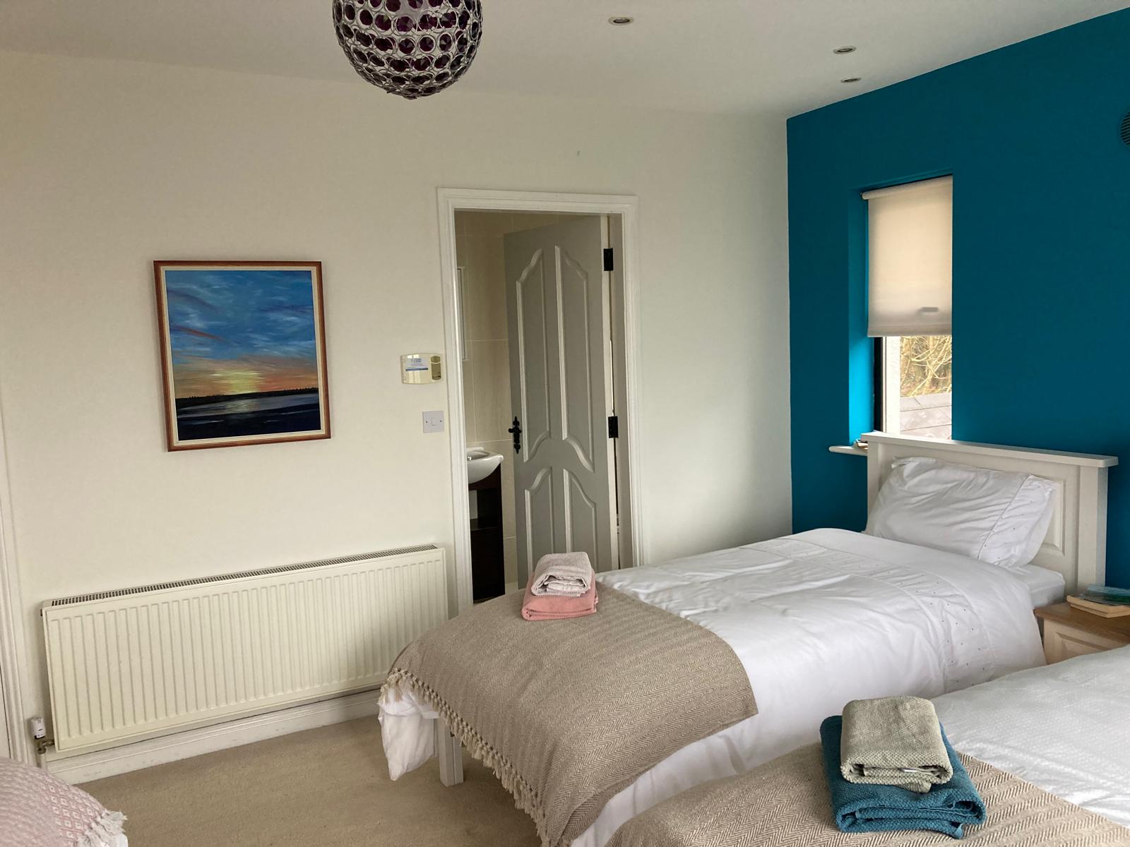 Twin beds, fresh towels and morning light