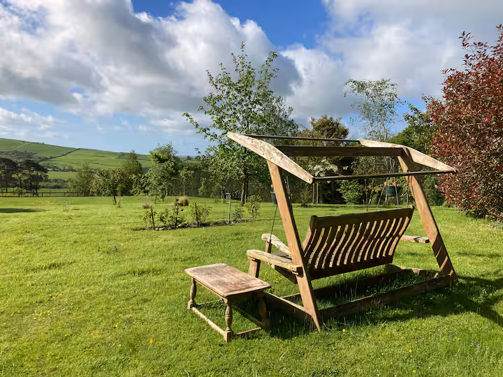 Garden swing seat in the orchard