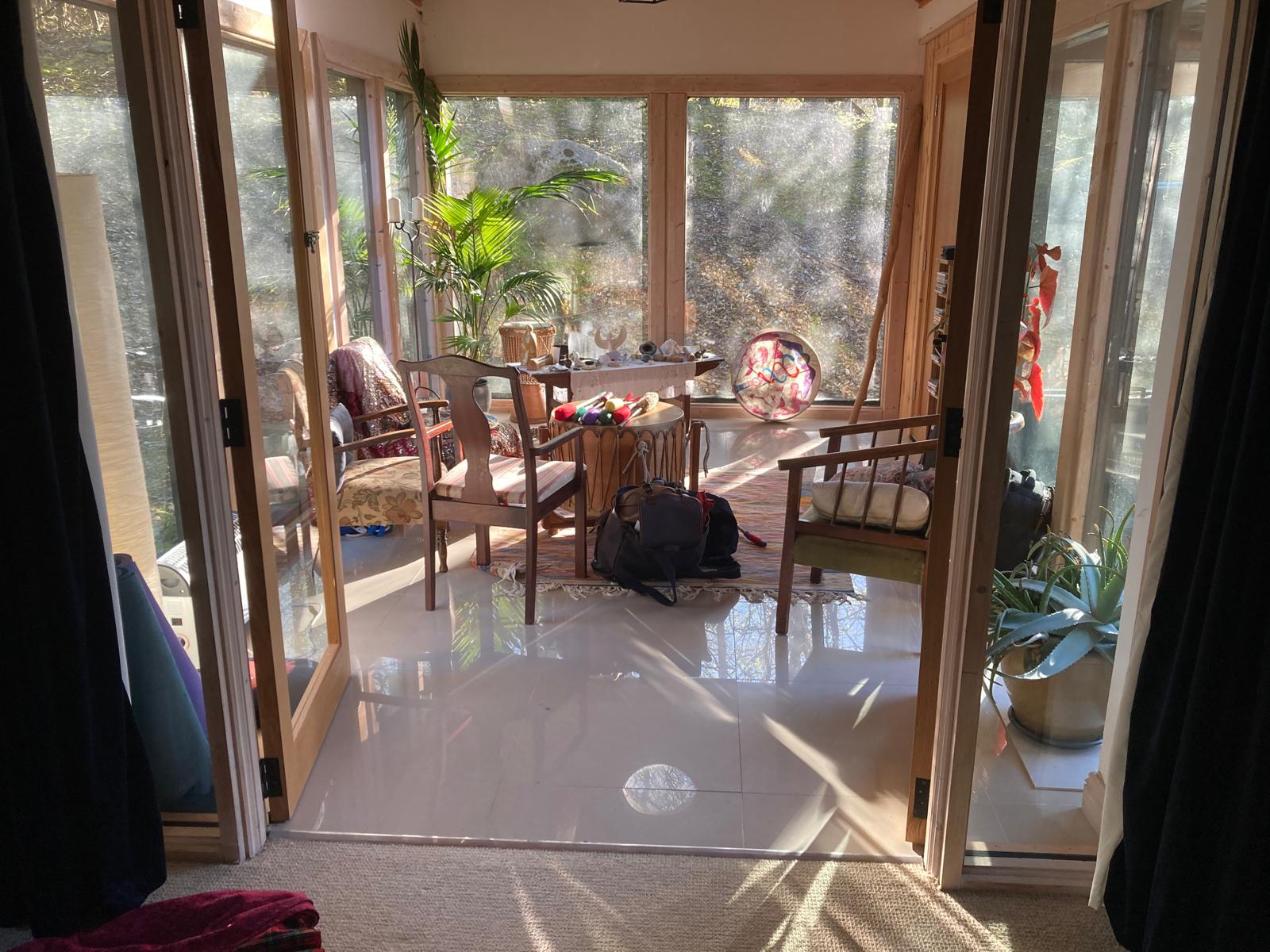 The sunroom altar — drums, rattles and the painted bodhrán