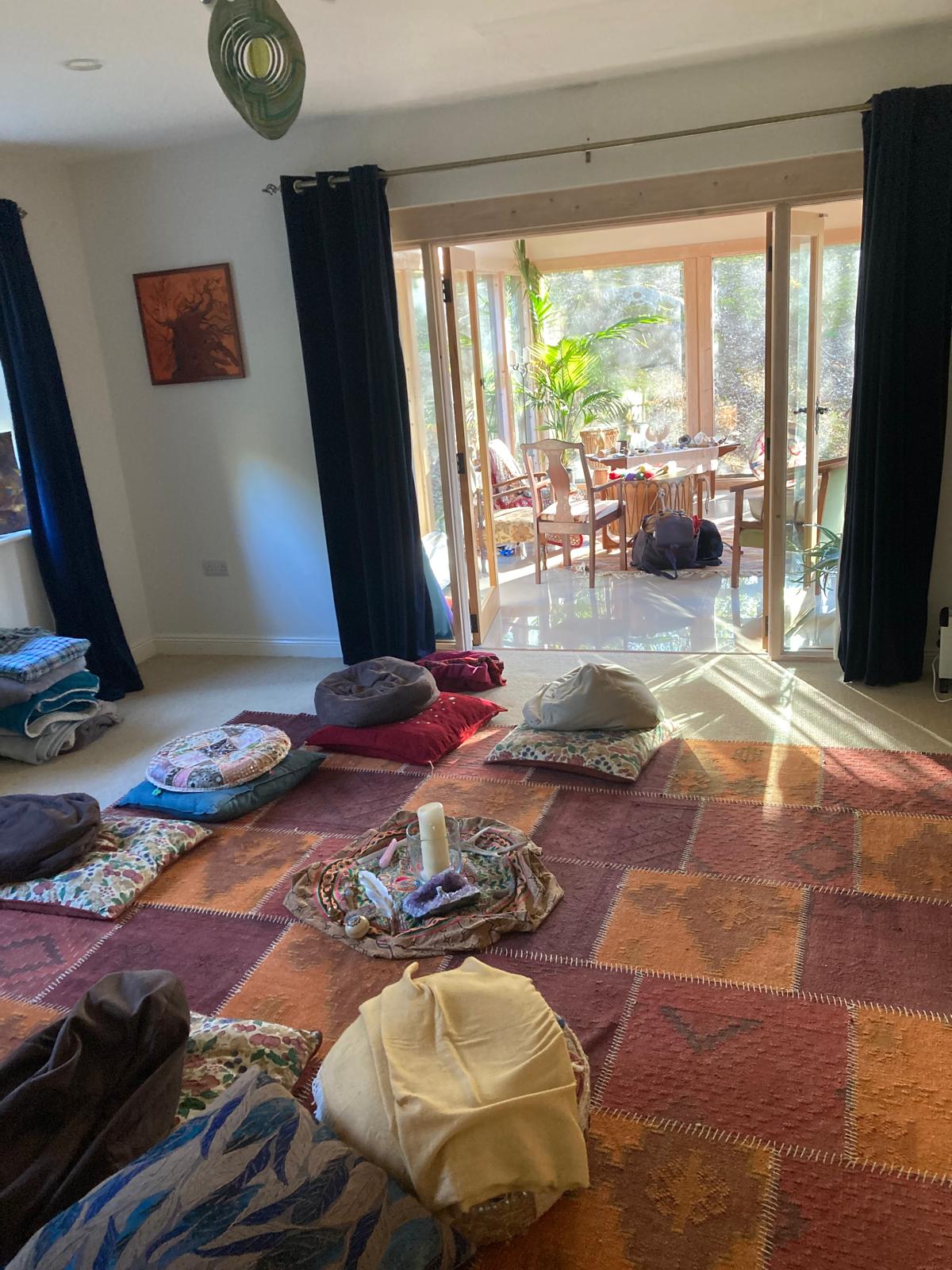 The ceremony room laid out — cushions, blankets and a candle at centre